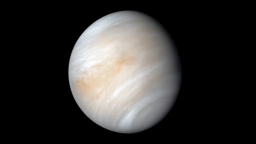 Venus glows with a soft yellow-white hue, completely shrouded in thick, smooth clouds. No surface features are visible through its dense atmosphere.